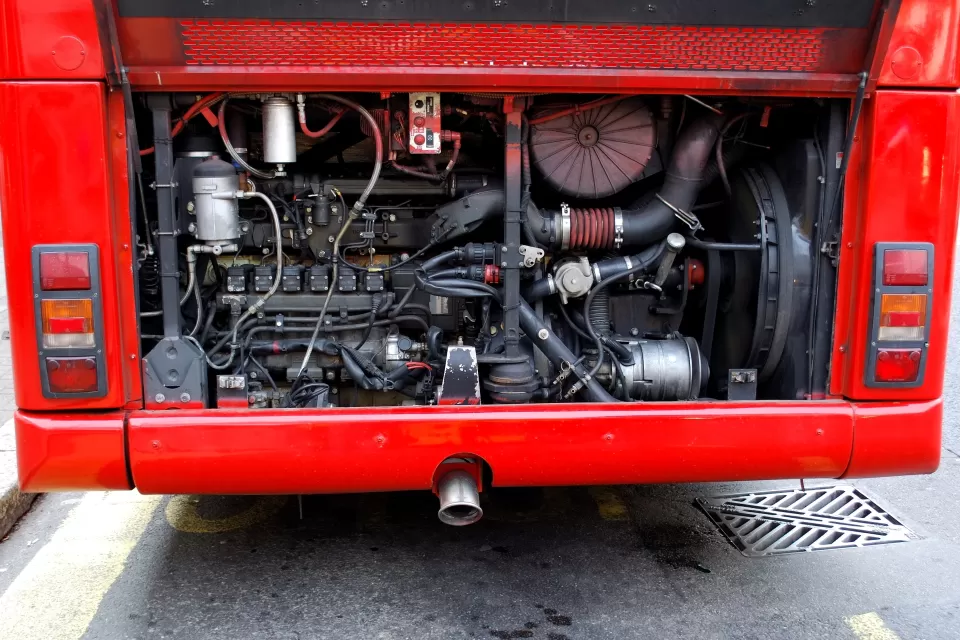 A view of the mechanics of the engine at the back of a public bus.